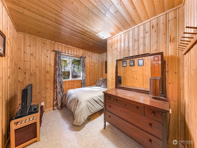 bedroom with wooden walls, carpet, and wooden ceiling