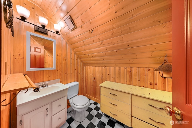 bathroom with lofted ceiling, wood walls, wooden ceiling, vanity, and toilet