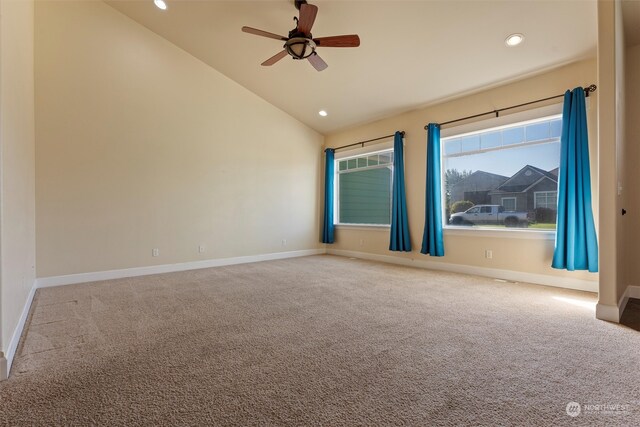 carpeted spare room featuring lofted ceiling and ceiling fan