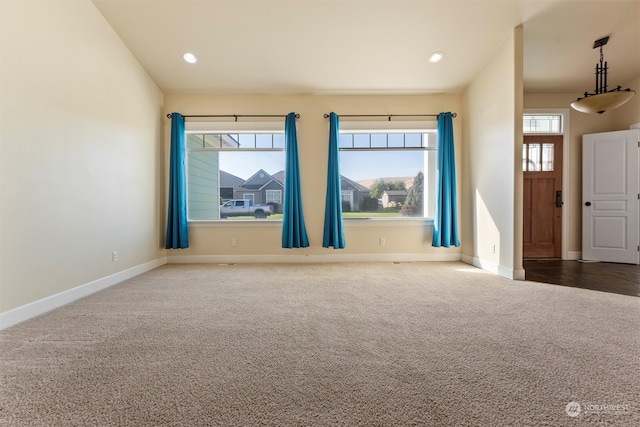 carpeted empty room with a wealth of natural light