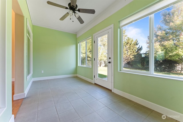 unfurnished sunroom with ceiling fan