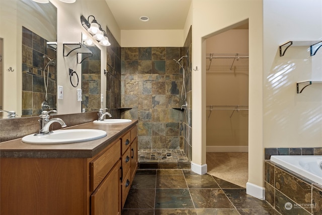 bathroom with vanity and independent shower and bath