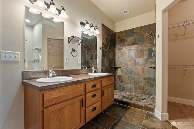 bathroom featuring vanity and tiled shower