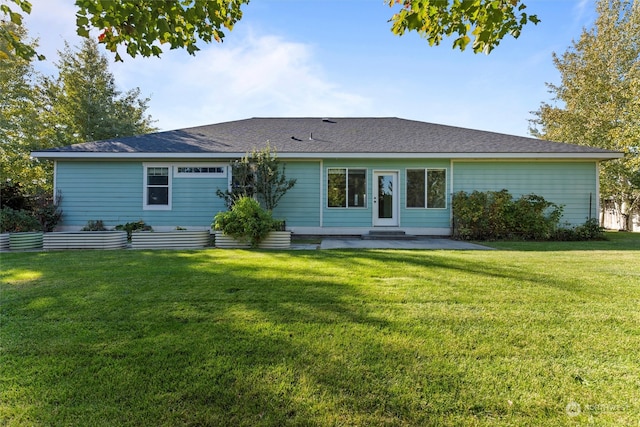 rear view of property featuring a yard