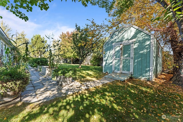 view of outbuilding featuring a yard