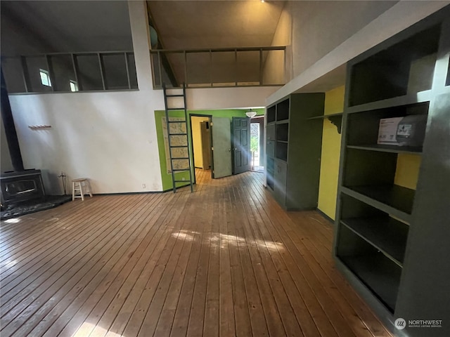 hallway featuring wood-type flooring and a high ceiling