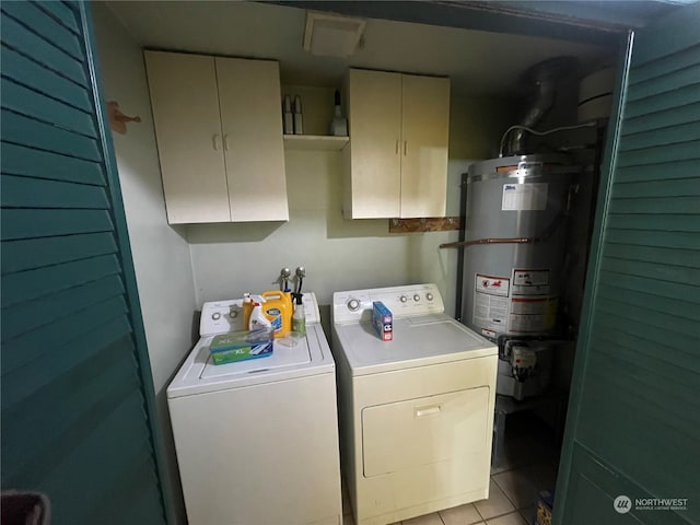 clothes washing area with water heater, light tile patterned flooring, separate washer and dryer, and cabinets