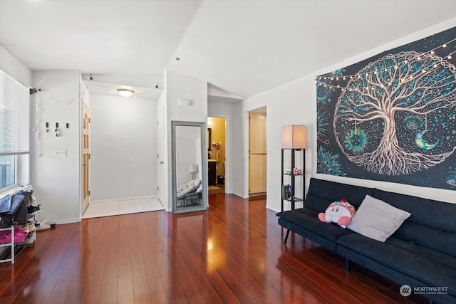 living room featuring vaulted ceiling and hardwood / wood-style floors