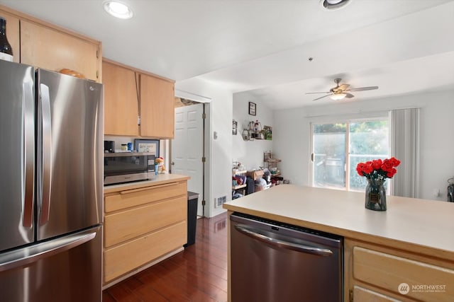 kitchen featuring dark hardwood / wood-style floors, lofted ceiling, light brown cabinets, appliances with stainless steel finishes, and ceiling fan