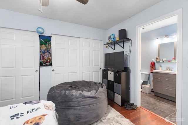 bedroom with a closet, ceiling fan, and hardwood / wood-style flooring