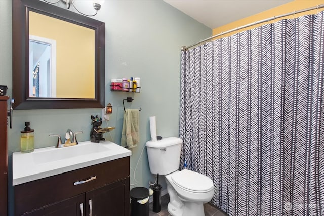 bathroom with vanity, toilet, and tile patterned floors