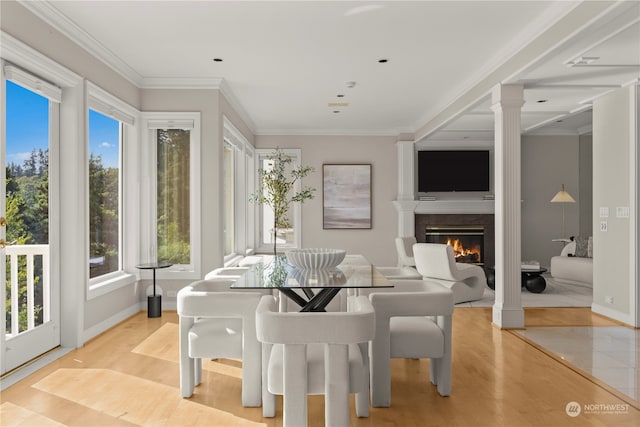 dining area featuring light hardwood / wood-style flooring, a high end fireplace, and crown molding