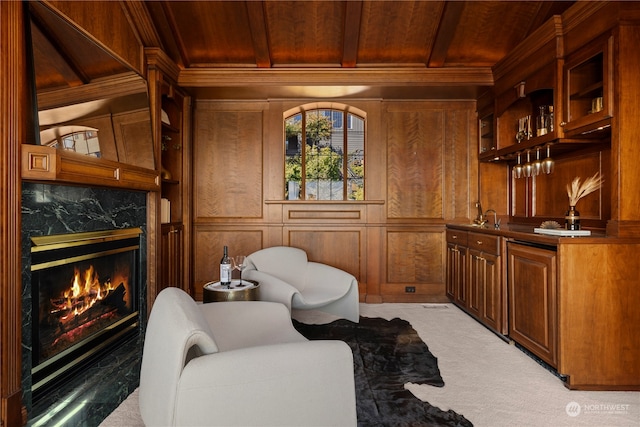 living area with wood walls, wood ceiling, a fireplace, and light colored carpet