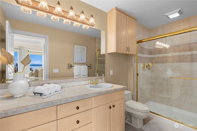 bathroom with vanity, toilet, tile patterned floors, and an enclosed shower