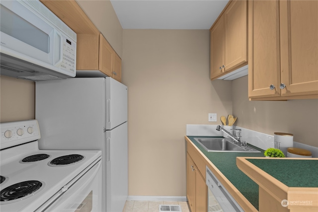 kitchen with white appliances, sink, light tile patterned floors, and light brown cabinets