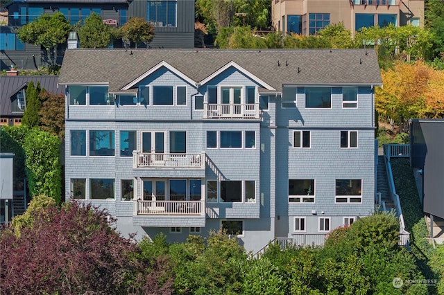 back of property featuring a balcony