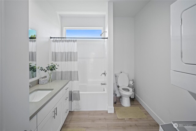 full bathroom featuring hardwood / wood-style floors, vanity, toilet, and shower / bath combination with curtain