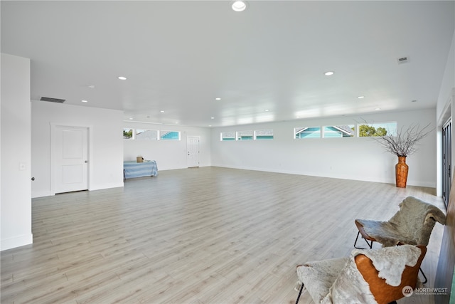 living room with light hardwood / wood-style flooring and a wealth of natural light