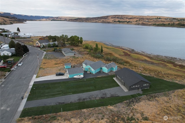 drone / aerial view featuring a water and mountain view