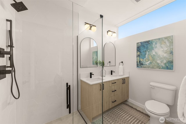 bathroom with tile patterned flooring, a sink, toilet, and a shower stall
