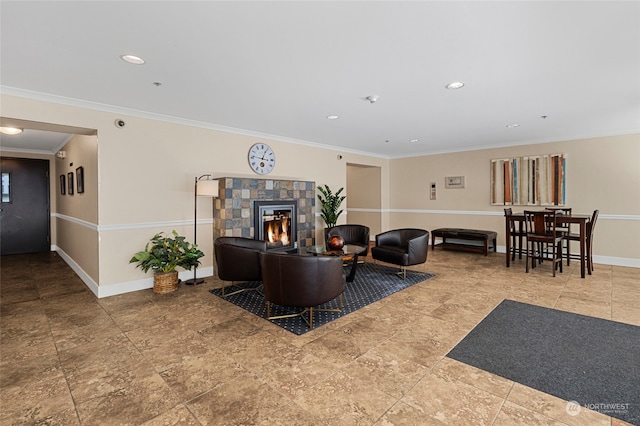 living room featuring crown molding and a tile fireplace