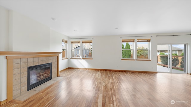 unfurnished living room with light hardwood / wood-style flooring and a fireplace