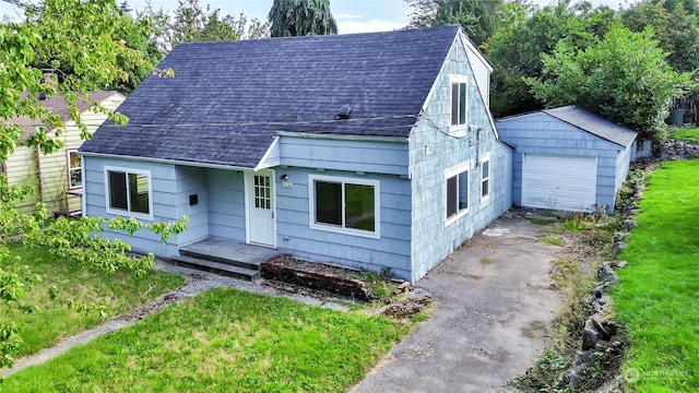 view of front of home with an outbuilding, a garage, and a front yard