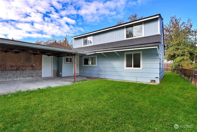 back of property with a lawn and a patio area