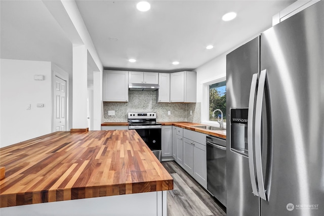 kitchen featuring light hardwood / wood-style floors, sink, butcher block counters, gray cabinetry, and stainless steel appliances