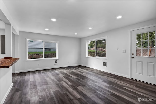 unfurnished living room featuring dark wood-type flooring