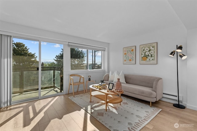 living room featuring light wood-type flooring and baseboard heating