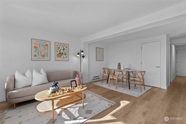 living room with light hardwood / wood-style floors and a baseboard radiator