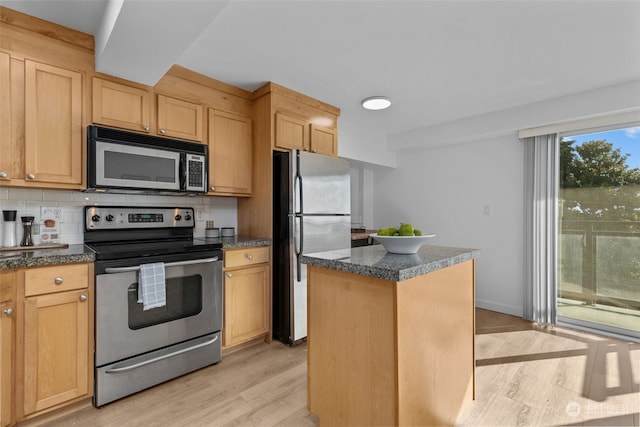 kitchen with a center island, light hardwood / wood-style flooring, stainless steel appliances, backsplash, and light brown cabinetry