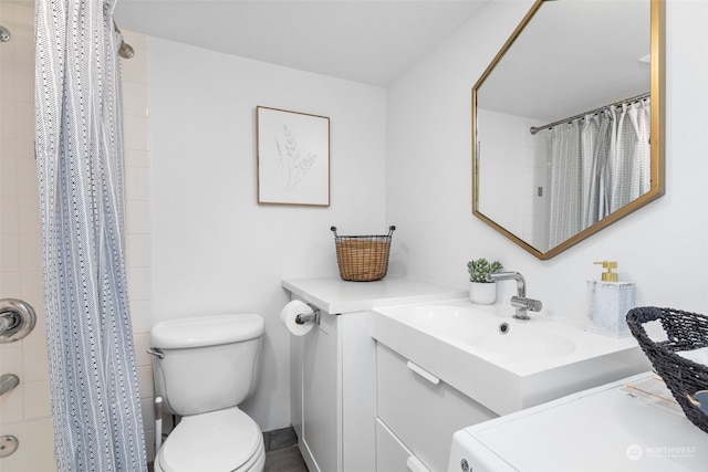 bathroom featuring washer / clothes dryer, vanity, toilet, and a shower with shower curtain