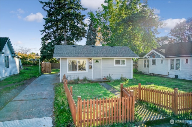 bungalow-style home with a front yard