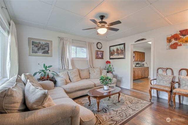 living room featuring ceiling fan and hardwood / wood-style floors