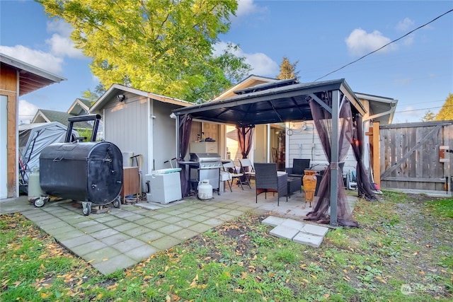 back of house with a gazebo and a patio area