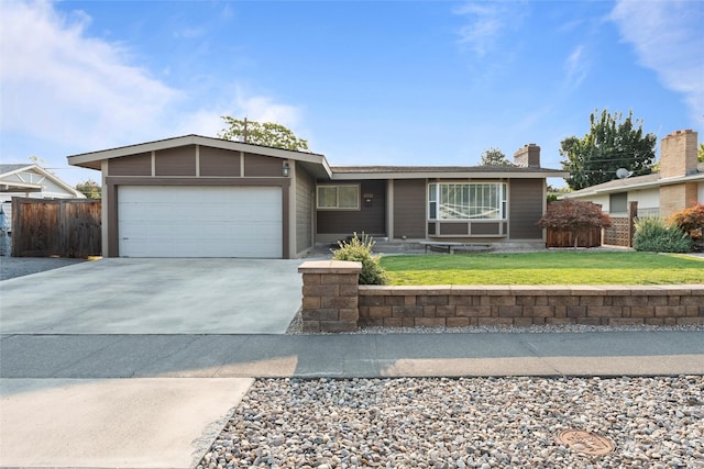 ranch-style house featuring a front yard and a garage