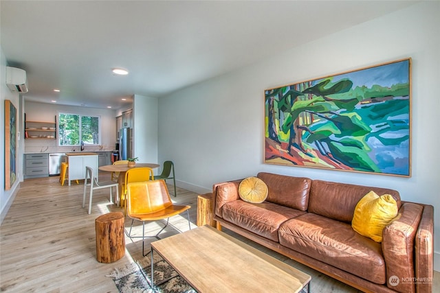 living room featuring a wall mounted AC and light hardwood / wood-style flooring