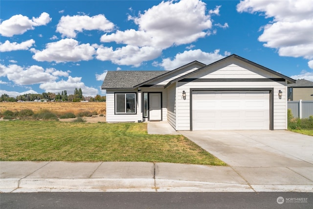 ranch-style home with a garage and a front lawn