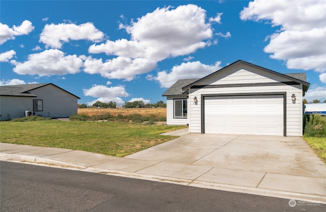 view of front of property with a garage and a front lawn