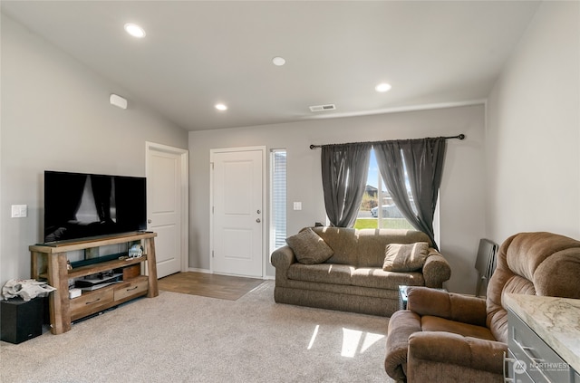 living room with light hardwood / wood-style flooring and vaulted ceiling