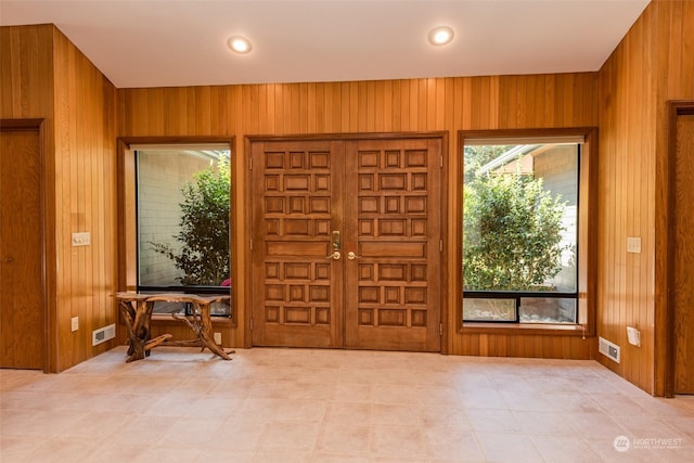 entryway featuring recessed lighting, wooden walls, and visible vents