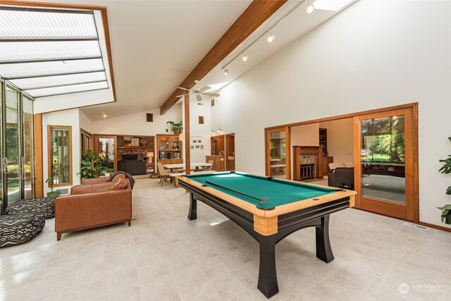 rec room with billiards, a fireplace, and a wealth of natural light