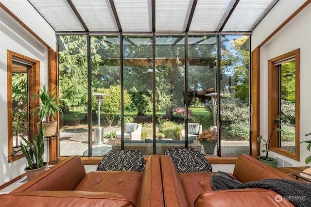 sunroom with a healthy amount of sunlight, outdoor lounge area, and visible vents