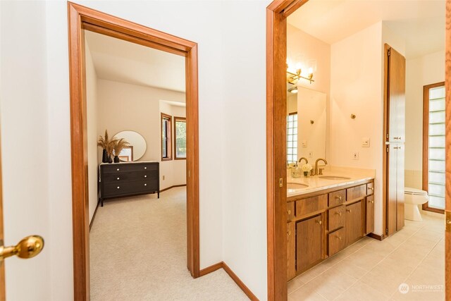 bathroom with tile patterned floors, vanity, and toilet