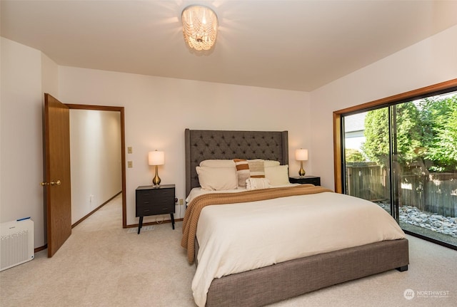 bedroom featuring baseboards, access to exterior, and light colored carpet