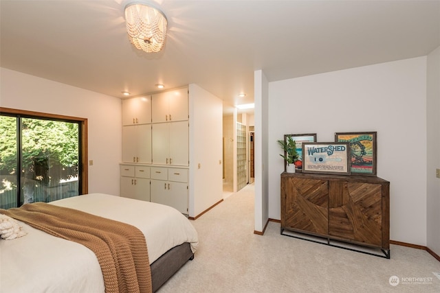 bedroom featuring baseboards, a notable chandelier, and light carpet
