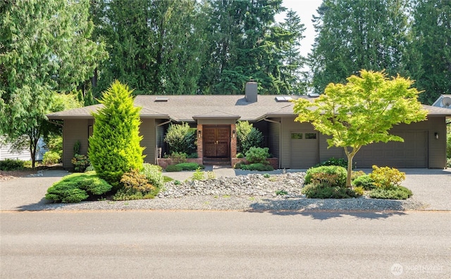 125 Arnold Palmer Pkwy, Sequim, WA 98382 - view of front of property featuring an attached garage, a chimney, driveway, and roof with shingles