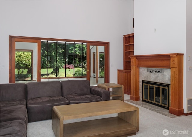 125 Arnold Palmer Pkwy, Sequim, WA 98382 - living room with a towering ceiling, a fireplace, and light colored carpet